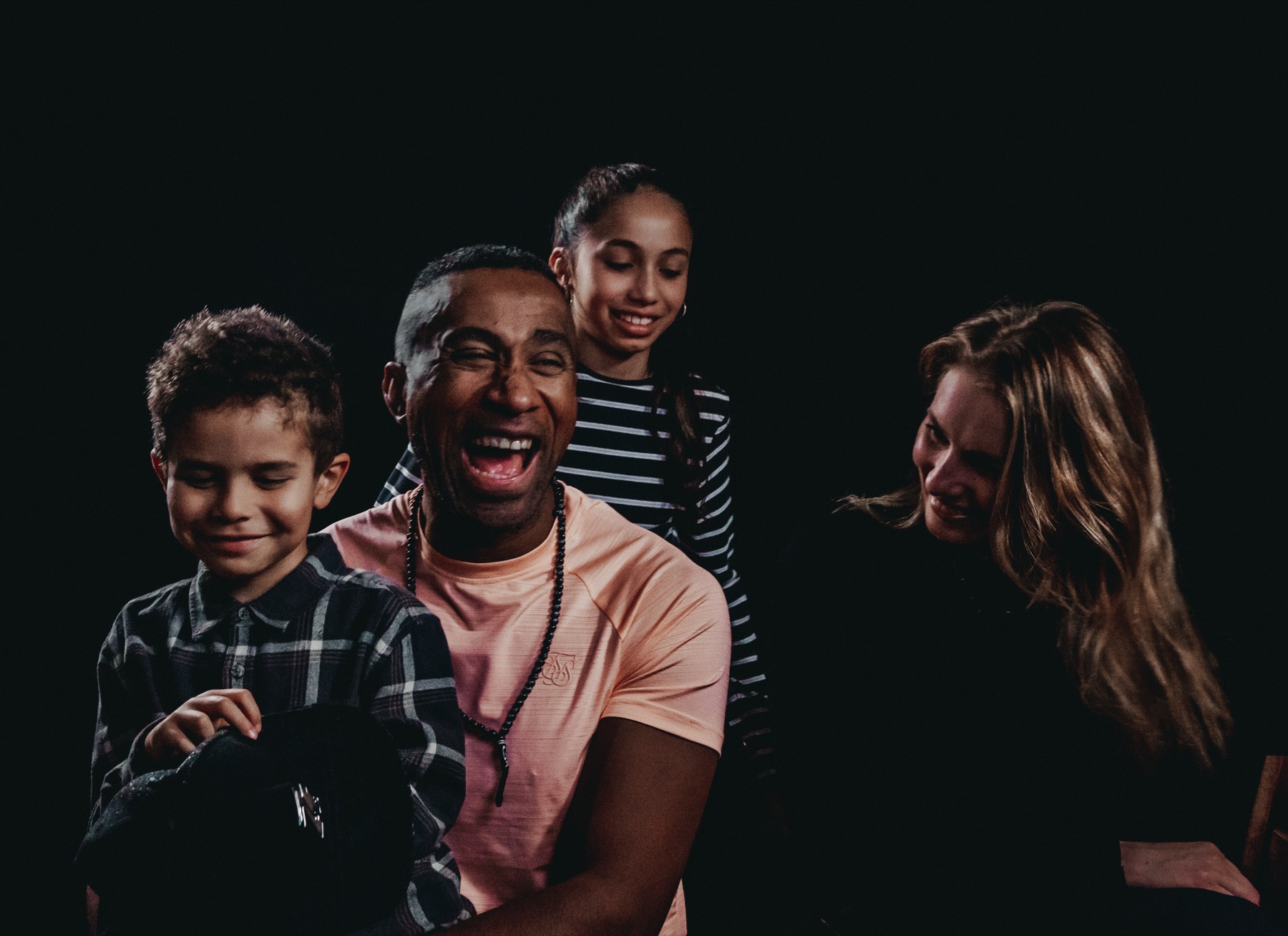 Eddy laughing, his family around him